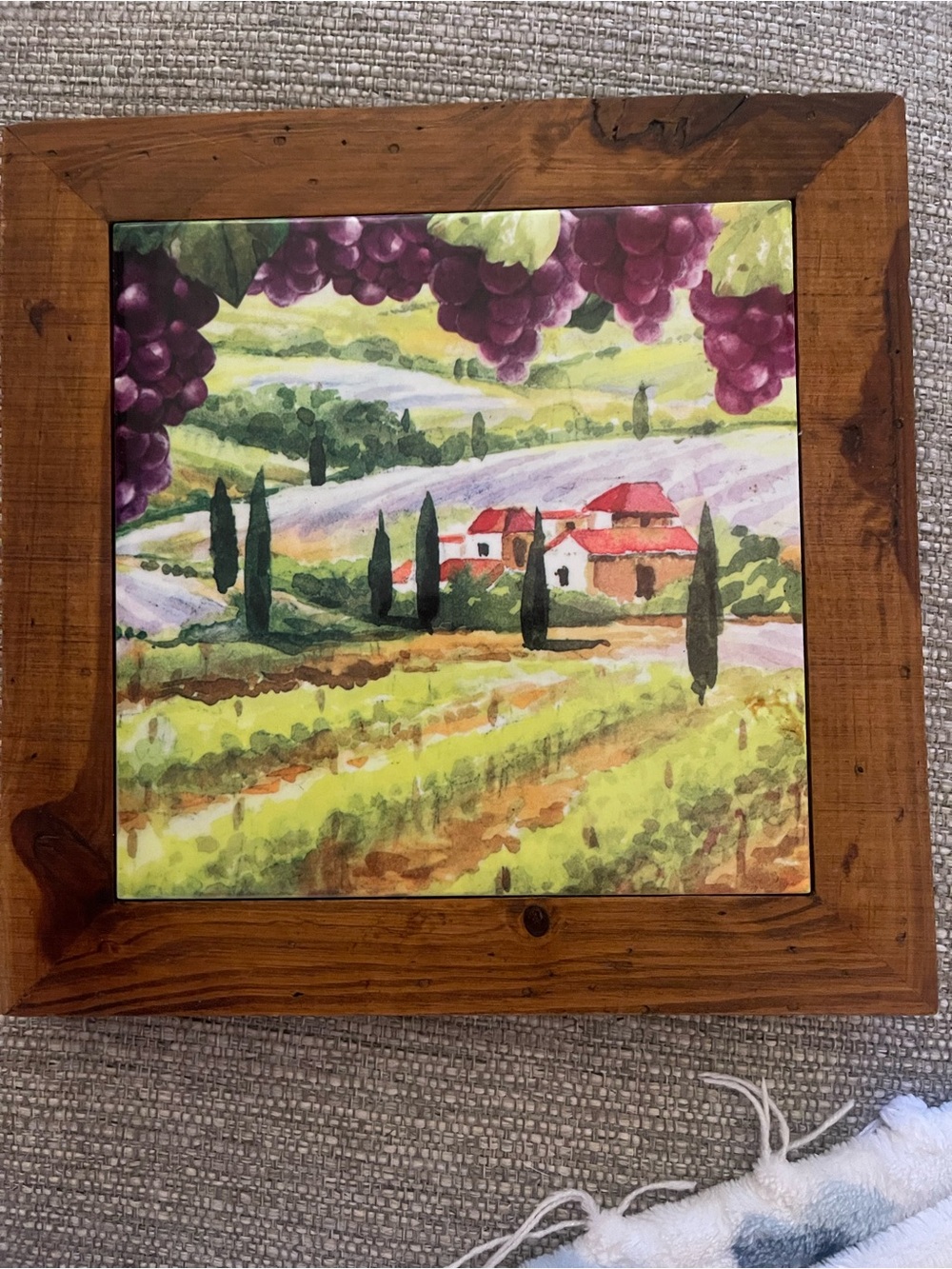 Ceramic decorative tile depicting a Tuscan vineyard landscape in a wooden frame